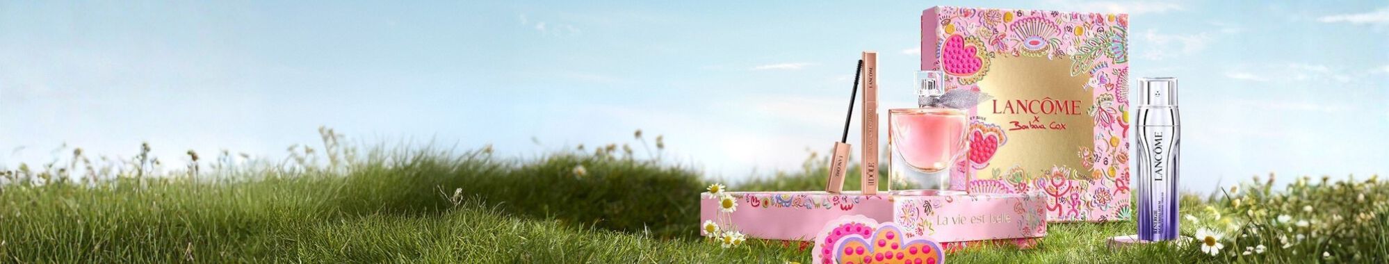 A visually striking arrangement of gift boxes stacked to form a pyramid, set against a dark background with whimsical star and moon illustrations.