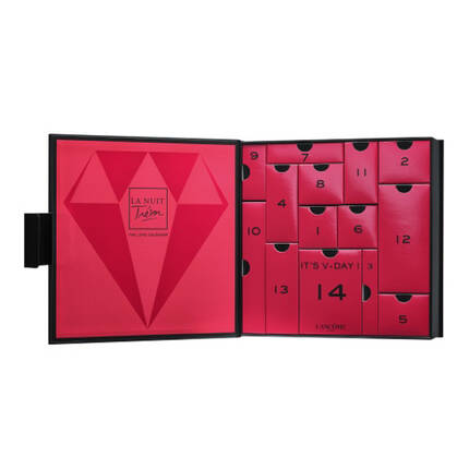 A visually striking pink Advent calendar with a diamond design, featuring numbered compartments and the text "IT'S V-DAY!" alongside the Lancome logo.