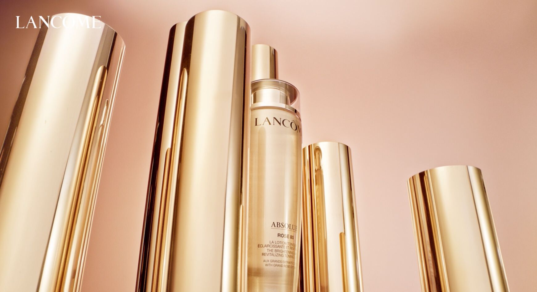 Flacoane de îngrijire a pielii Lancôme, cu un design elegant, strălucitor, pe un fundal subtil.